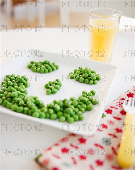 Close up of smiley on plate made of green peas. Photo: Jamie Grill