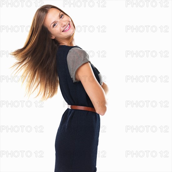 Portrait of pretty woman standing with hands folded and smiling. Photo : momentimages