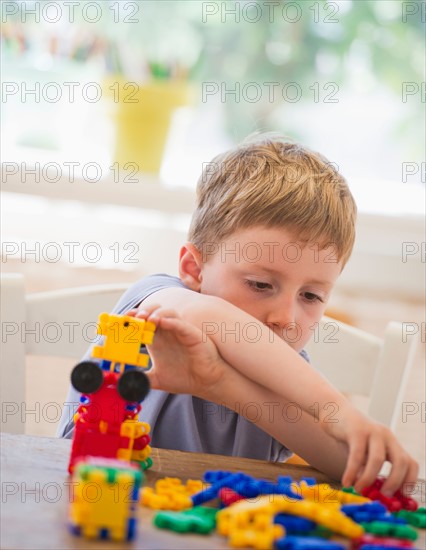 Close up of boy (4-5) playing with plastic blocks. Photo: Daniel Grill