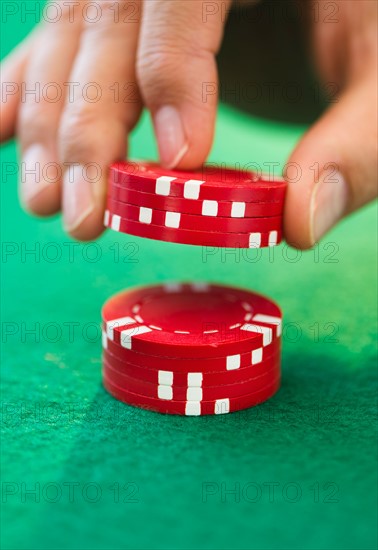 Hand handling gambling chips.