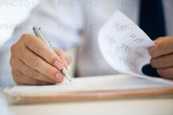 Businessman writing, close-up.