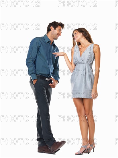 Playful couple smiling and looking at each other. Photo : momentimages