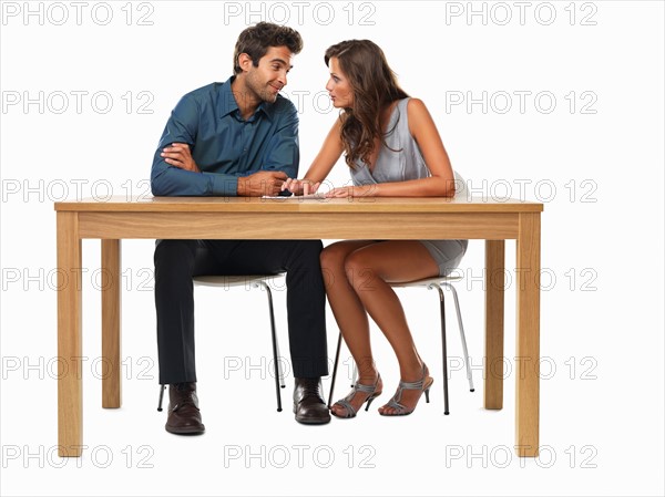 Couple sitting at table and discussing financial matter. Photo : momentimages