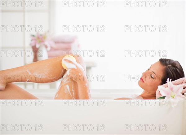 Young woman taking bath.