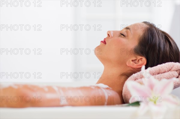 Young woman taking bath.