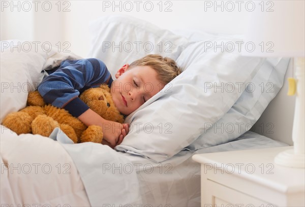 Close up of boy (4-5) sleeping in bed. Photo : Daniel Grill