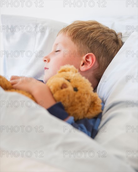 Close up of boy (4-5) sleeping in bed. Photo : Daniel Grill