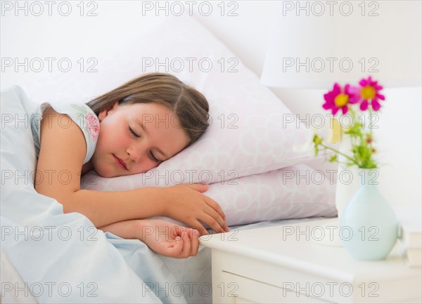 Close up of girl (6-7) sleeping in bed. Photo : Daniel Grill