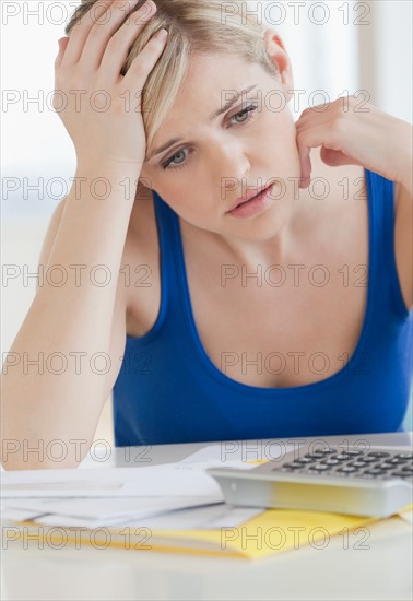 Young blond woman doing paperwork. Photo : Jamie Grill