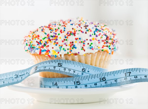 Close up of cupcake with measuring tape. Photo: Jamie Grill