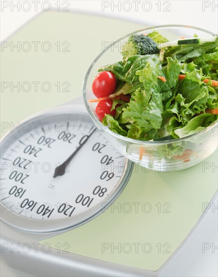 Bowl of salad on bathroom scale. Photo : Jamie Grill