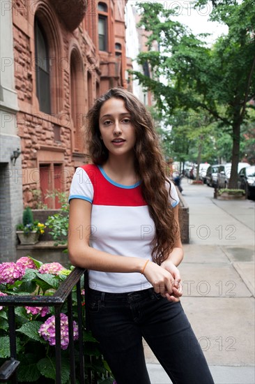 USA, New York, New York City, Portrait of young woman standing on street. Photo : Winslow Productions