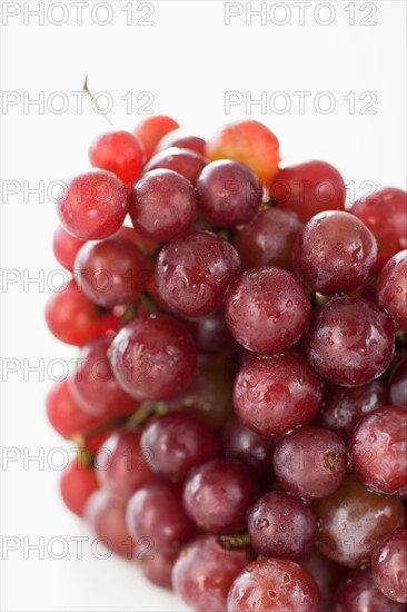 Fresh red grapes on white background.