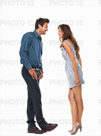 Playful couple smiling and looking at each other. Photo : momentimages