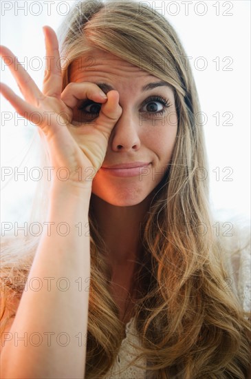 Portrait of blonde woman showing ok sign. Photo: Jamie Grill
