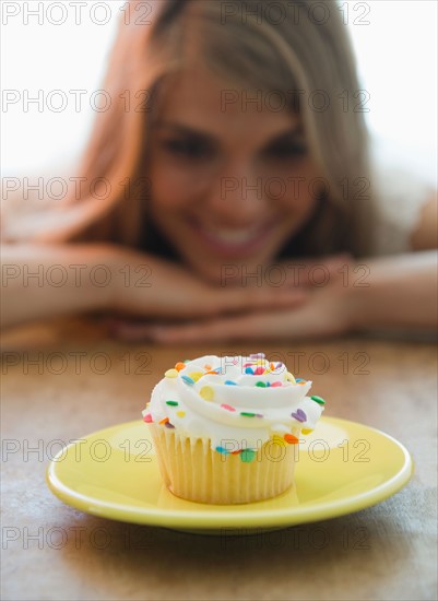 Close up of women looking at cupcake. Photo : Jamie Grill