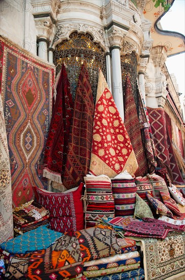 Turkey, Istanbul, Grand Bazaar, rugs and cushions for sale.