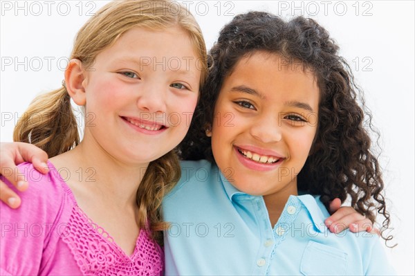 Portrait of two girls (8-9) embracing.