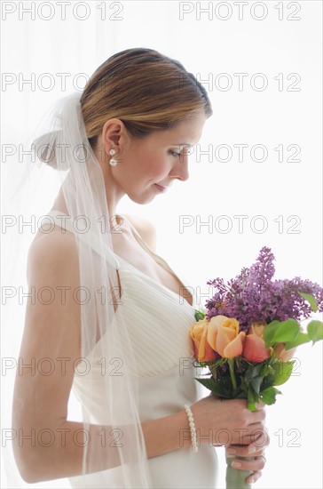 Bride holding floral bouquet.