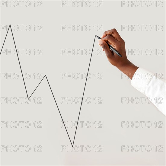 Close up of woman's hand drawing chart. Photo : Jamie Grill