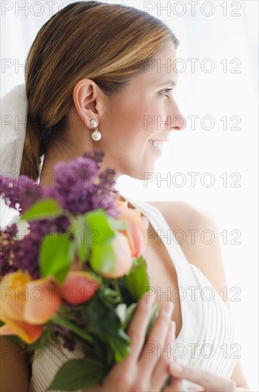 Bride holding floral bouquet.