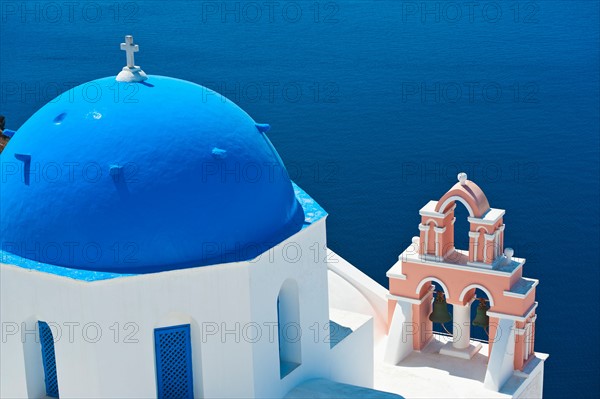 Greece, Cyclades Islands, Santorini, Oia, Church with bell tower by sea.