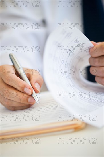 Businessman writing, close-up.