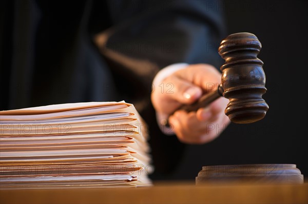 Judge holding gavel, close-up.