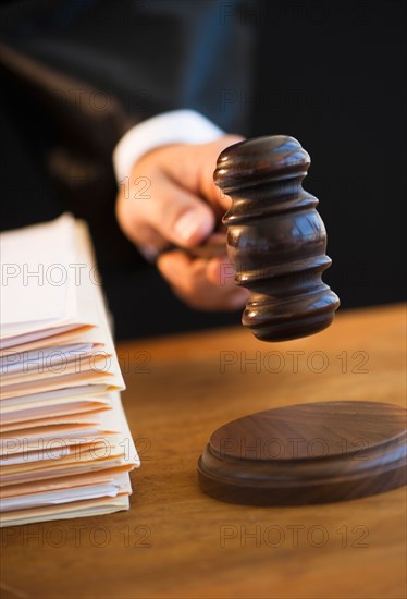 Judge holding gavel, close-up.