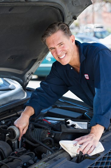 Mechanic repairing car.