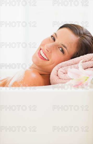 Young woman taking bath.