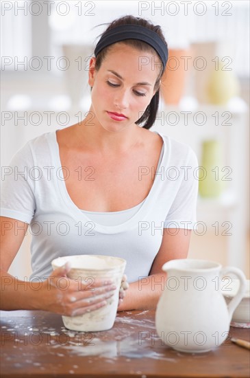 Woman making pottery.