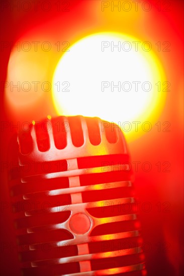 Antique microphone in spotlight.