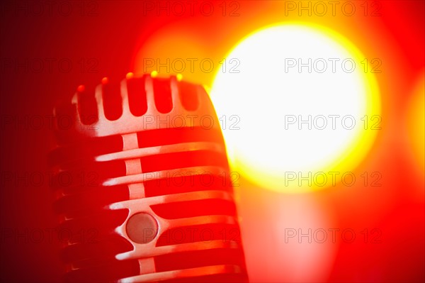 Antique microphone in spotlight.