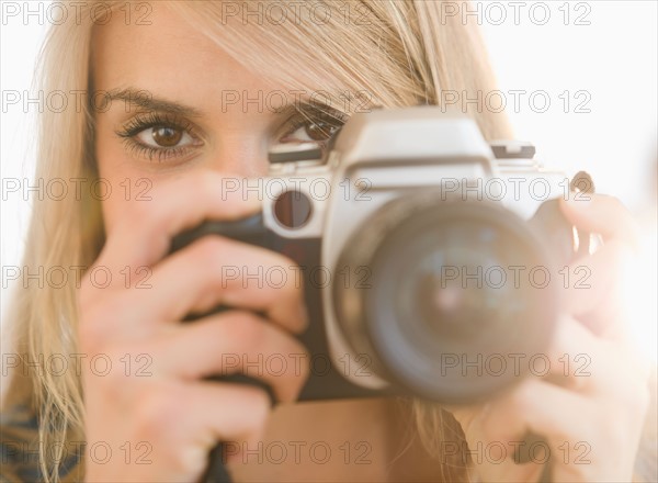 Portrait of woman holding camera. Photo: Jamie Grill