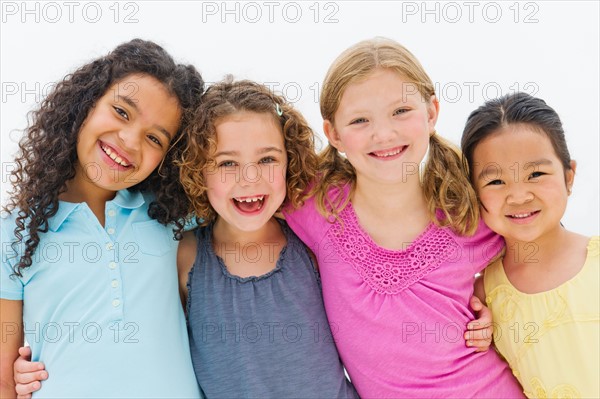 Studio portrait of embracing girls (6-7,8-9).