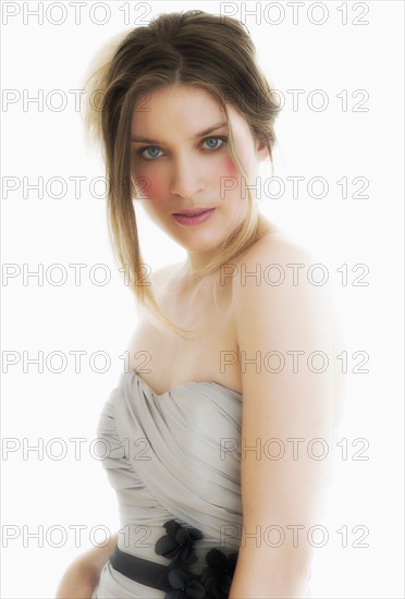 Studio portrait of young woman in evening wear.