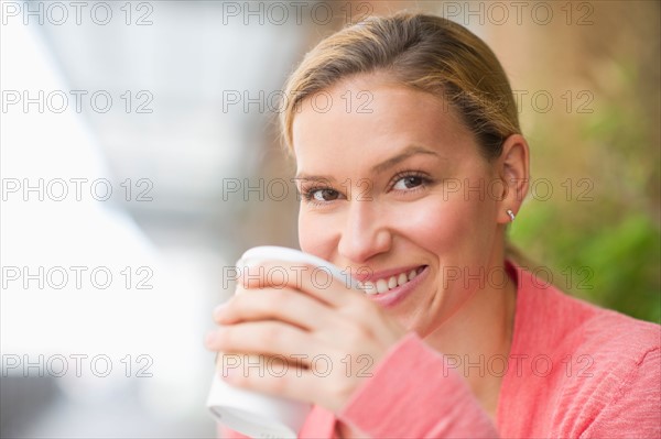 Woman drinking coffee.