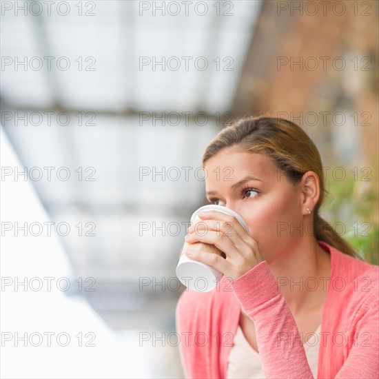 Woman drinking coffee.