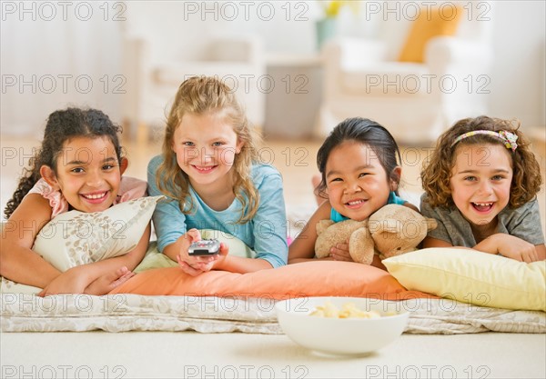 Portrait of girls (6-9) watching TV.