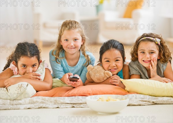 Portrait of girls (6-9) watching TV.