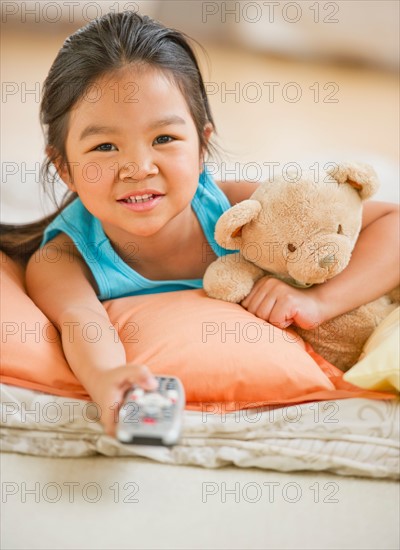 Portrait of girl (6-7) watching TV.