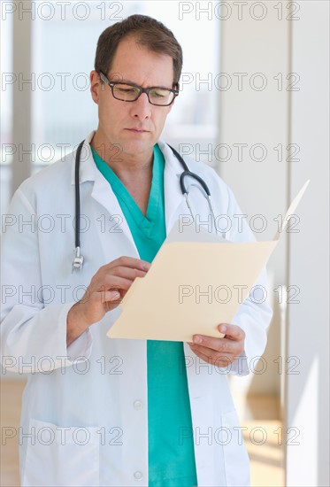 Doctor writing in clipboard.