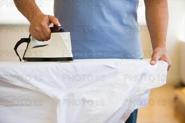 Man ironing shirt.