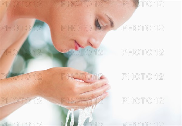 Woman washing face.