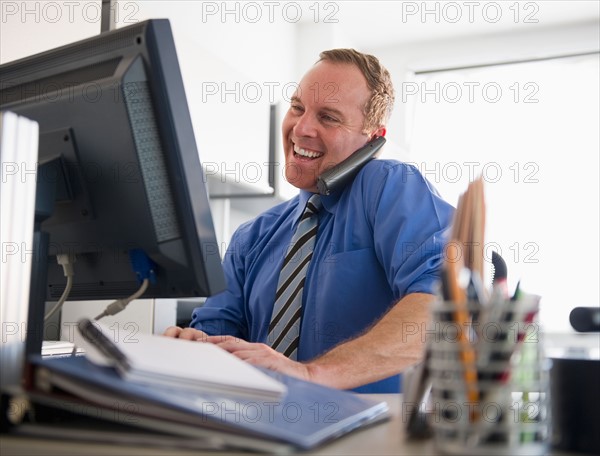 Businessman working in office. Photo : Jamie Grill