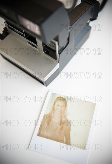 Close up of photograph of woman and polaroid camera. Photo : Jamie Grill