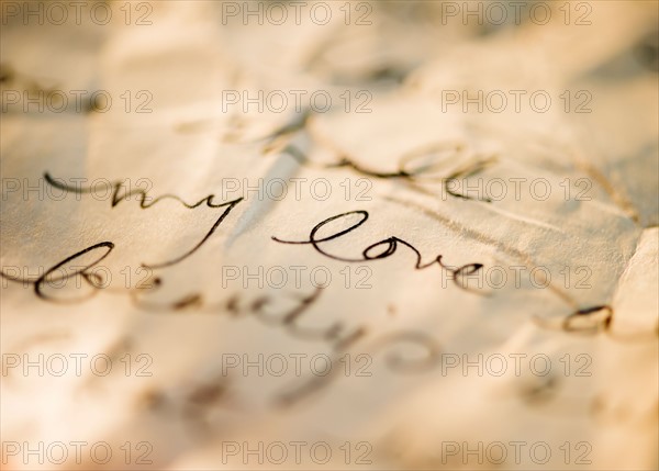 Close up of antique love letter on parchment . Photo : Jamie Grill