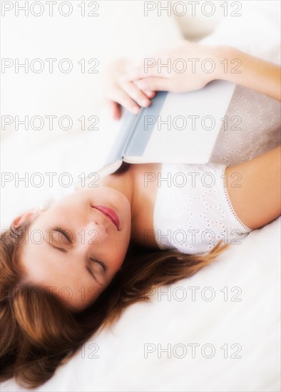 Sensual portrait of young woman with book. Photo: Daniel Grill