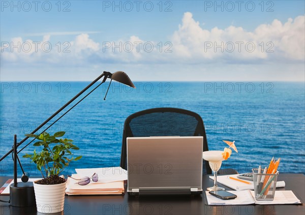 Close up of office desk with sea and sky in backgrounds. Photo : Daniel Grill